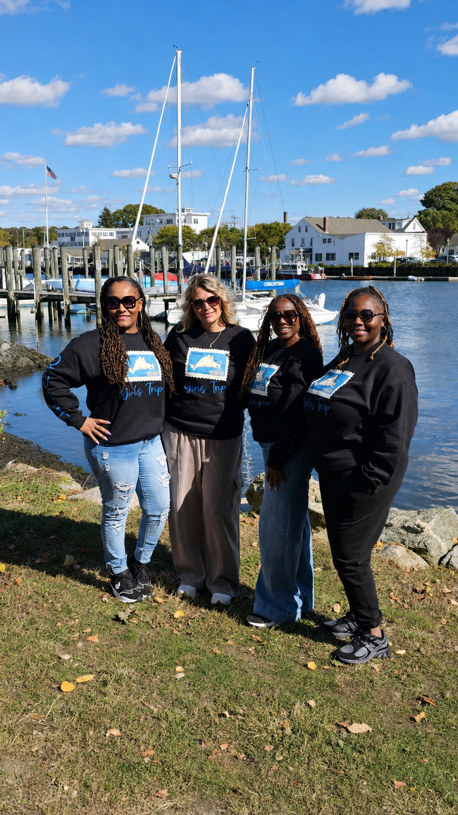 Four friends enjoying a sunny day beside a marina