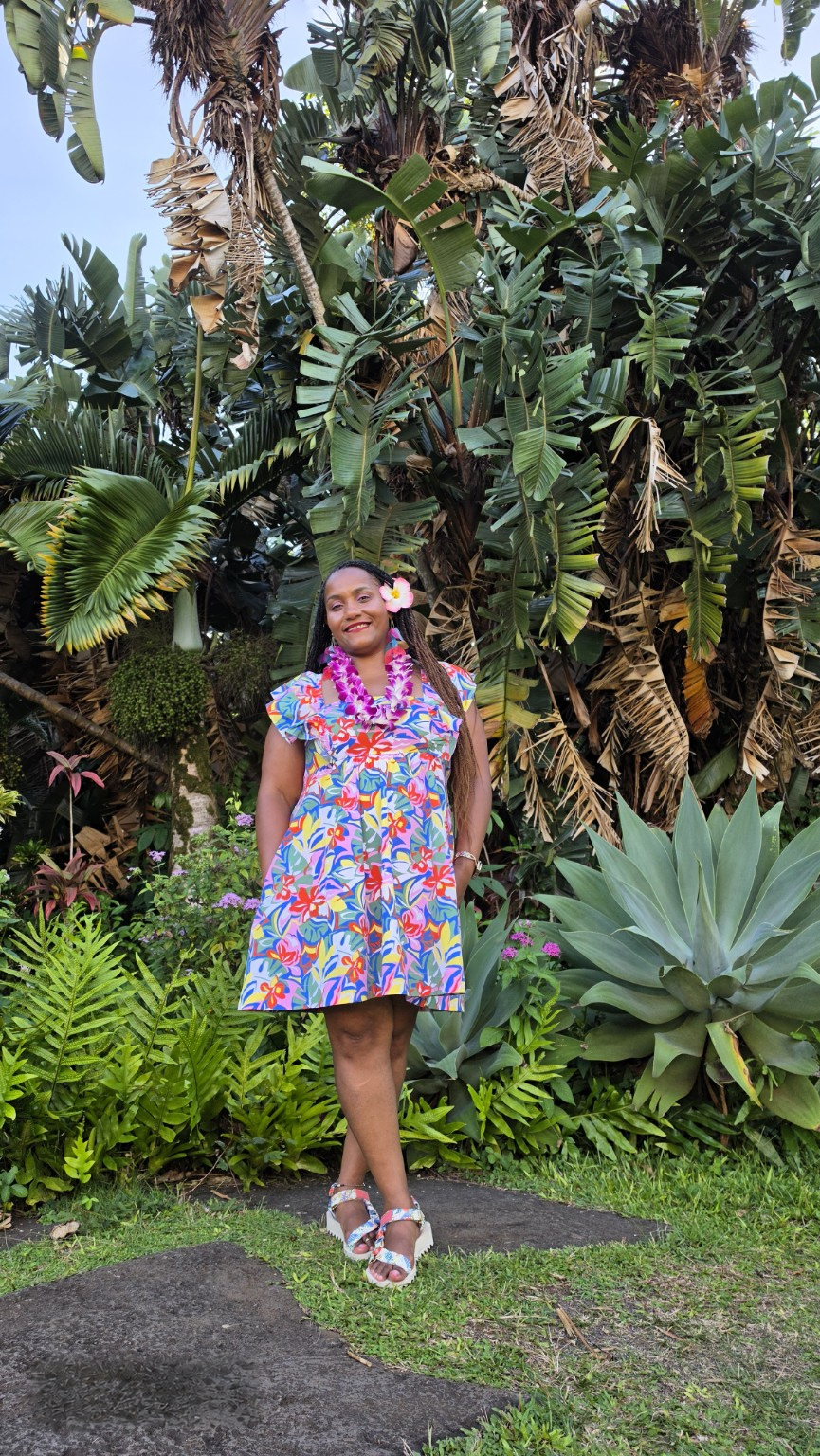 Leslie smiling in a tropical garden
