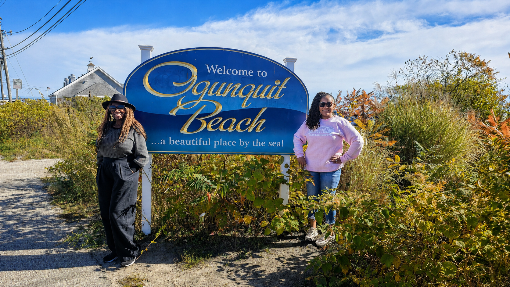 Leslie and a friend beside the welcome sign at Ogunquit Beach