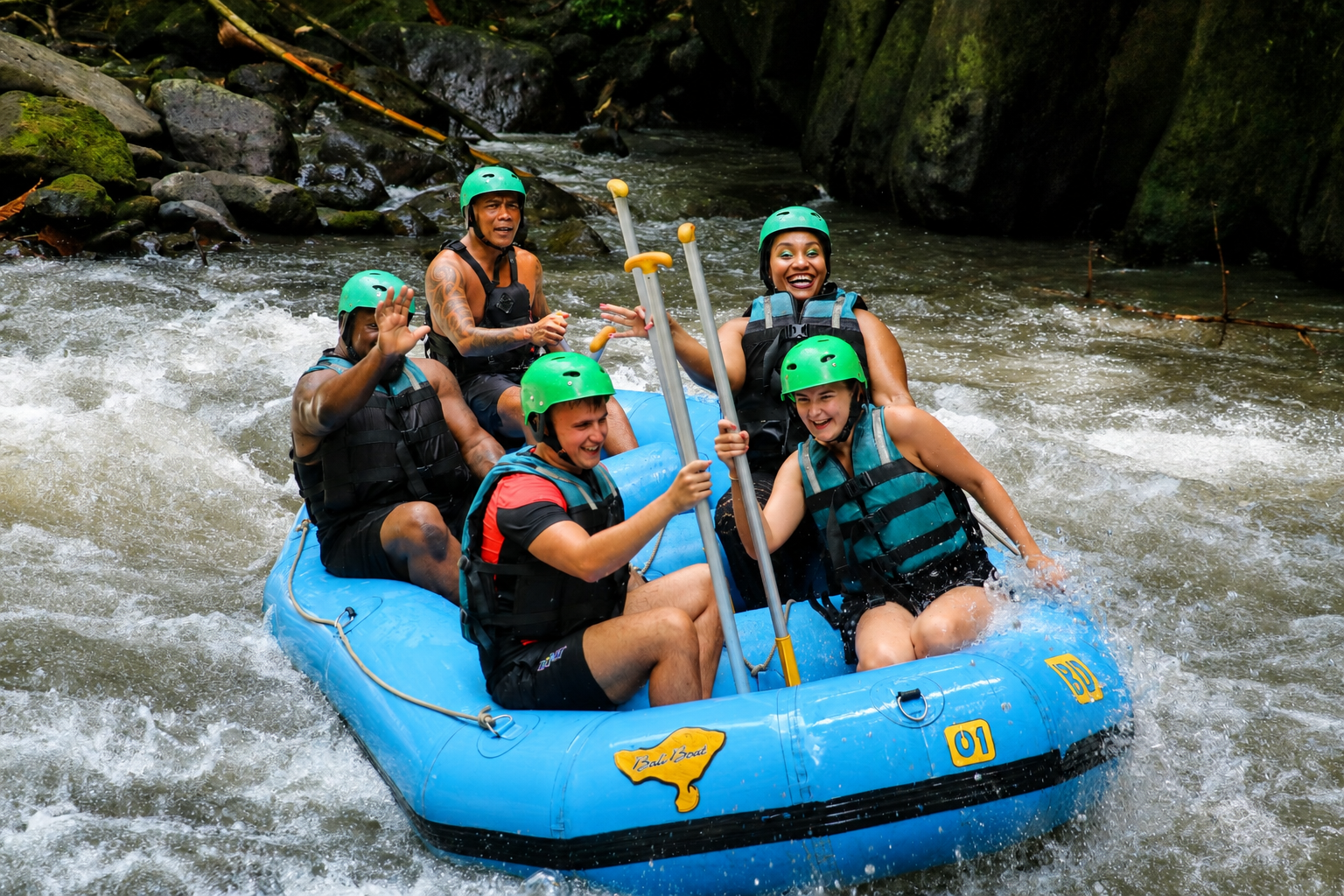 A group white-water rafting through tropical rapids in Bali